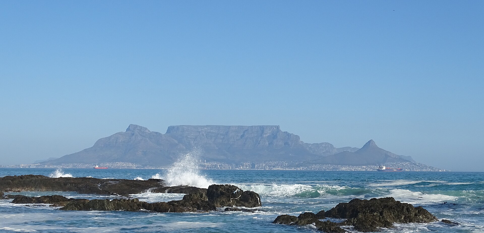 The sun setting over the Atlantic at Bloubergstrand, with Table Mountain silhouetted across Table Bay